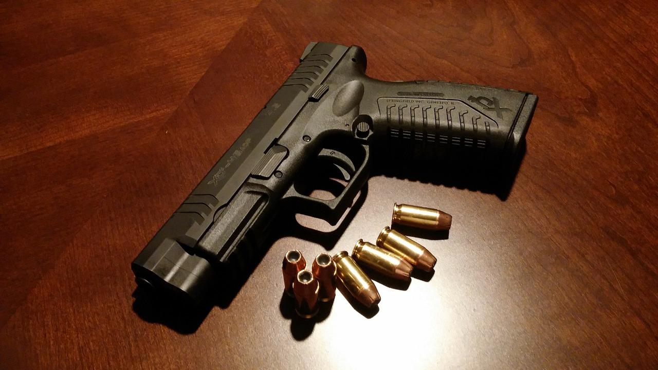A sleek, compact handgun rests on the counter, its polished metal surface gleaming under the overhead light. Its presence is both formidable and unassuming, a testament to its potent potential.